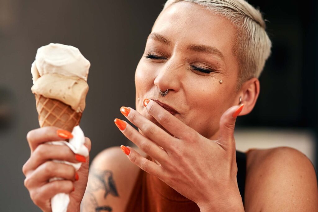 cropped-shot-of-a-young-woman-enjoying-a-ice-cream-AADT9UU.jpg
